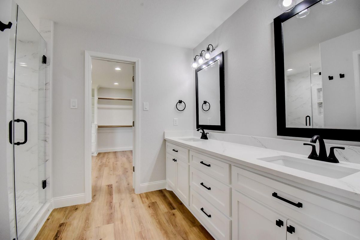 Bathroom, Dual Sink Vanities, Interior, Marble Walls, Recessed Lighting, Wood Texture Flooring