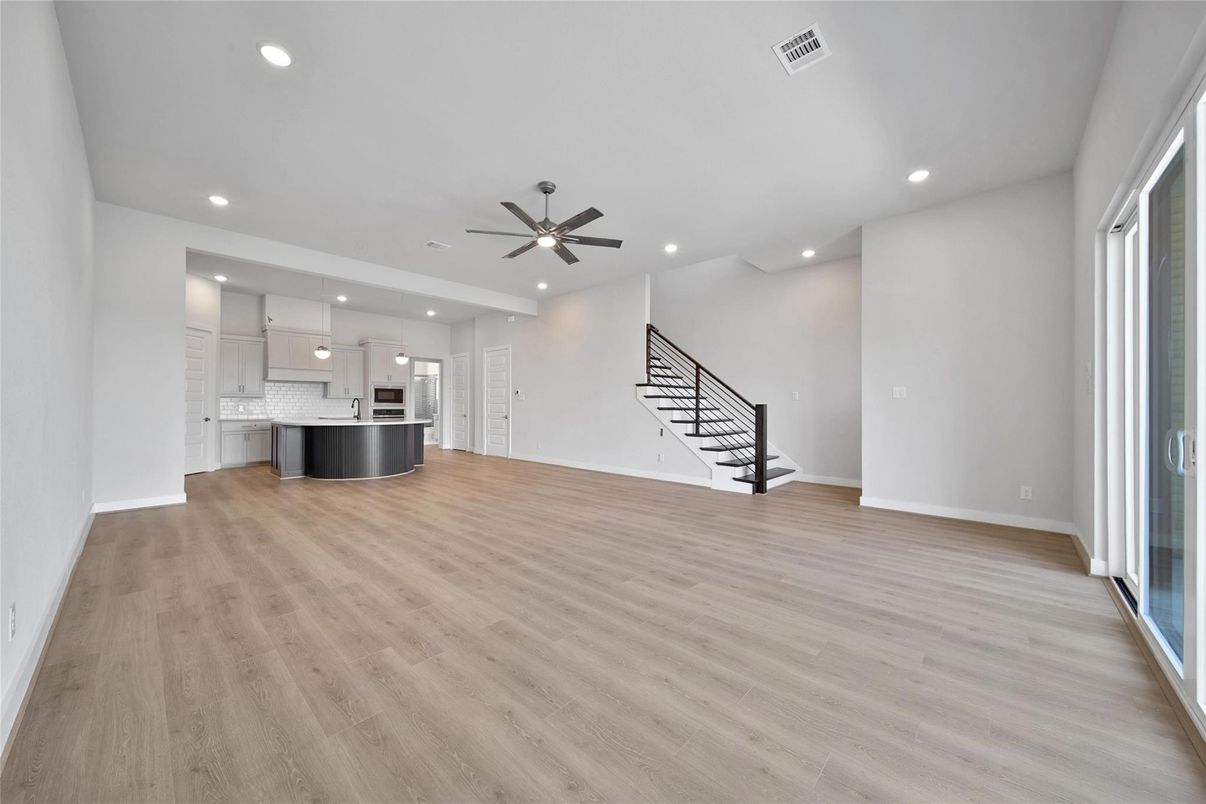 Empty room, Interior, Kitchen, Pendant Lights, Recessed Lighting, Stainless Steel Appliances, Wood Texture Flooring