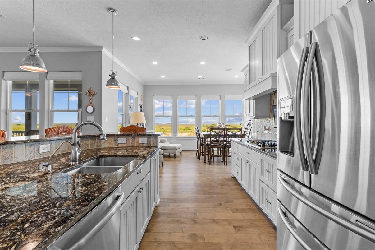 Dining room, Interior, Kitchen, Pendant Lights, Recessed Lighting, Stainless Steel Appliances, Wood Texture Flooring