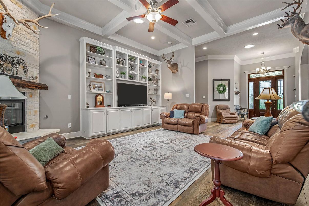 Chandelier, Fireplace, Interior, Living room, Recessed Lighting, Stone Walls, Wood Texture Flooring