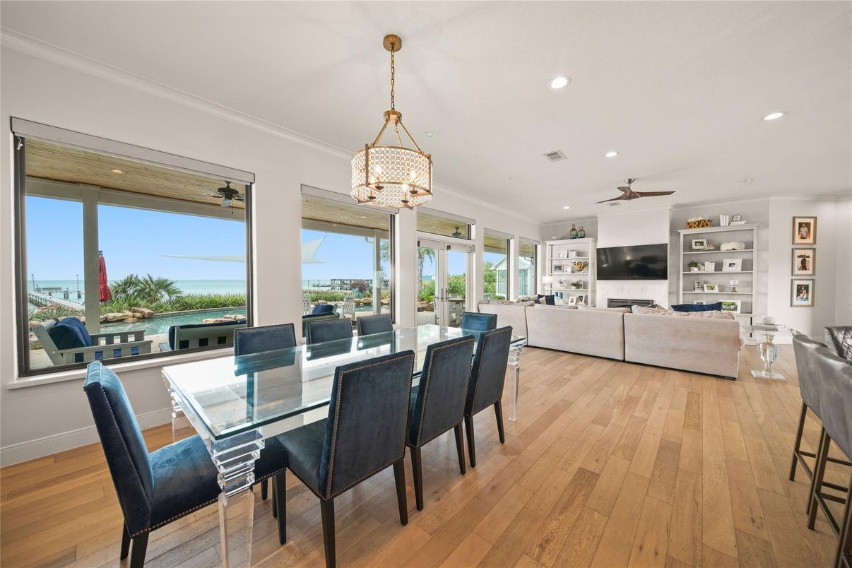 Dining room, Fireplace, Interior, Living room, Pendant Lights, Recessed Lighting, Water, Wood Texture Flooring
