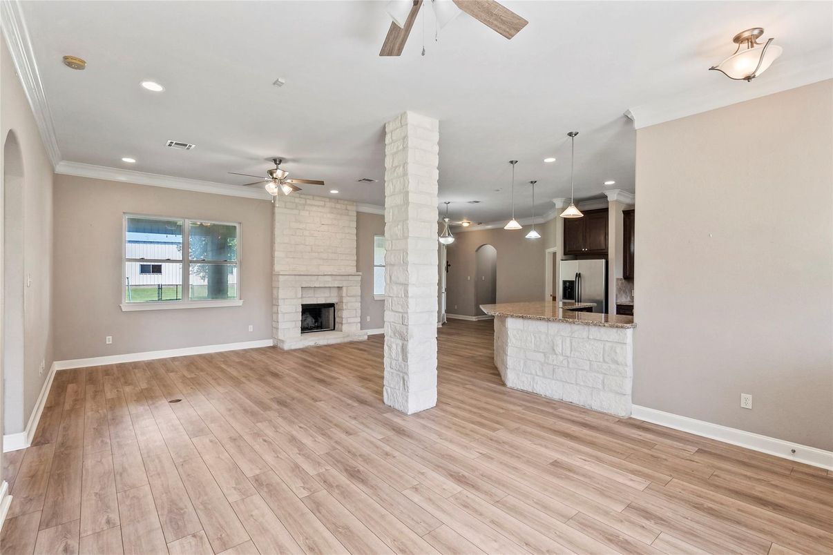 Empty room, Fireplace, Interior, Kitchen, Pendant Lights, Recessed Lighting, Stone Walls, Wood Texture Flooring