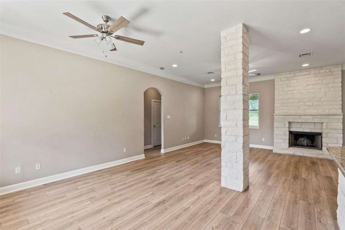 Empty room, Fireplace, Interior, Recessed Lighting, Stone Walls, Wood Texture Flooring
