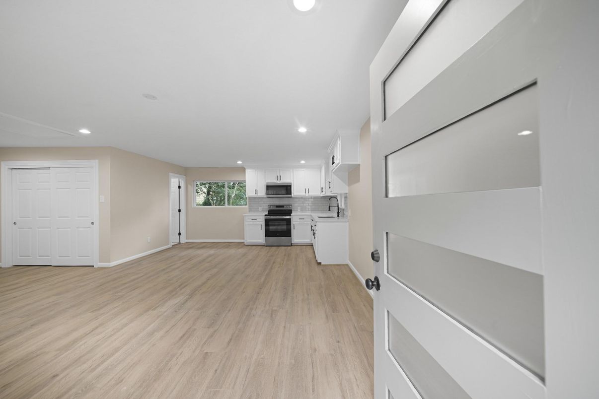 Empty room, Interior, Kitchen, Recessed Lighting, Stainless Steel Appliances, Wood Texture Flooring