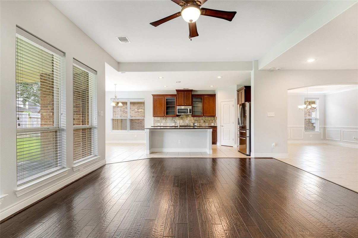 Chandelier, Empty room, Interior, Kitchen, Pendant Lights, Recessed Lighting, Stainless Steel Appliances, Wood Texture Flooring