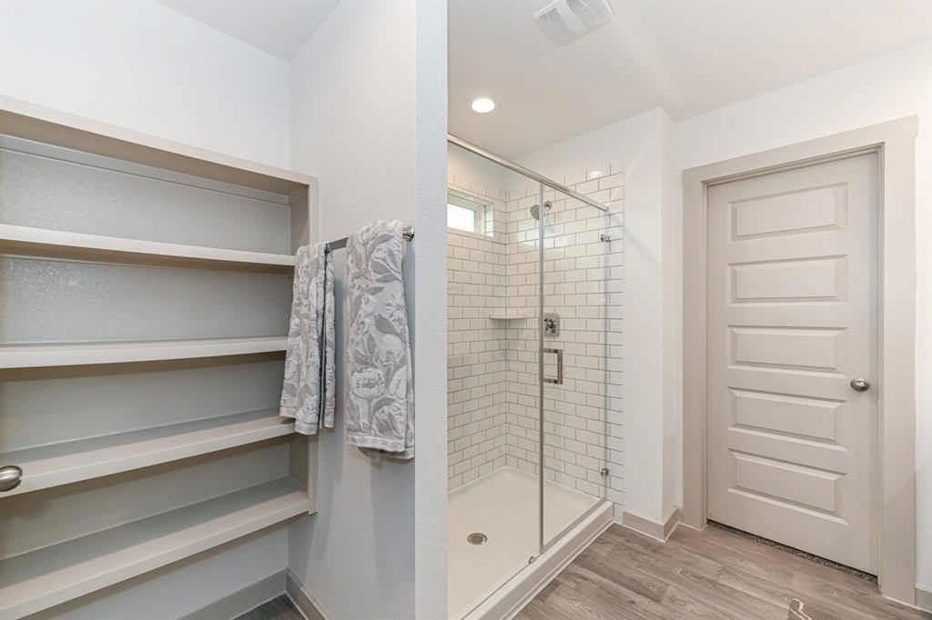 Bathroom, Glass Shower, Interior, Recessed Lighting, Walk-in Closets, Wood Texture Flooring