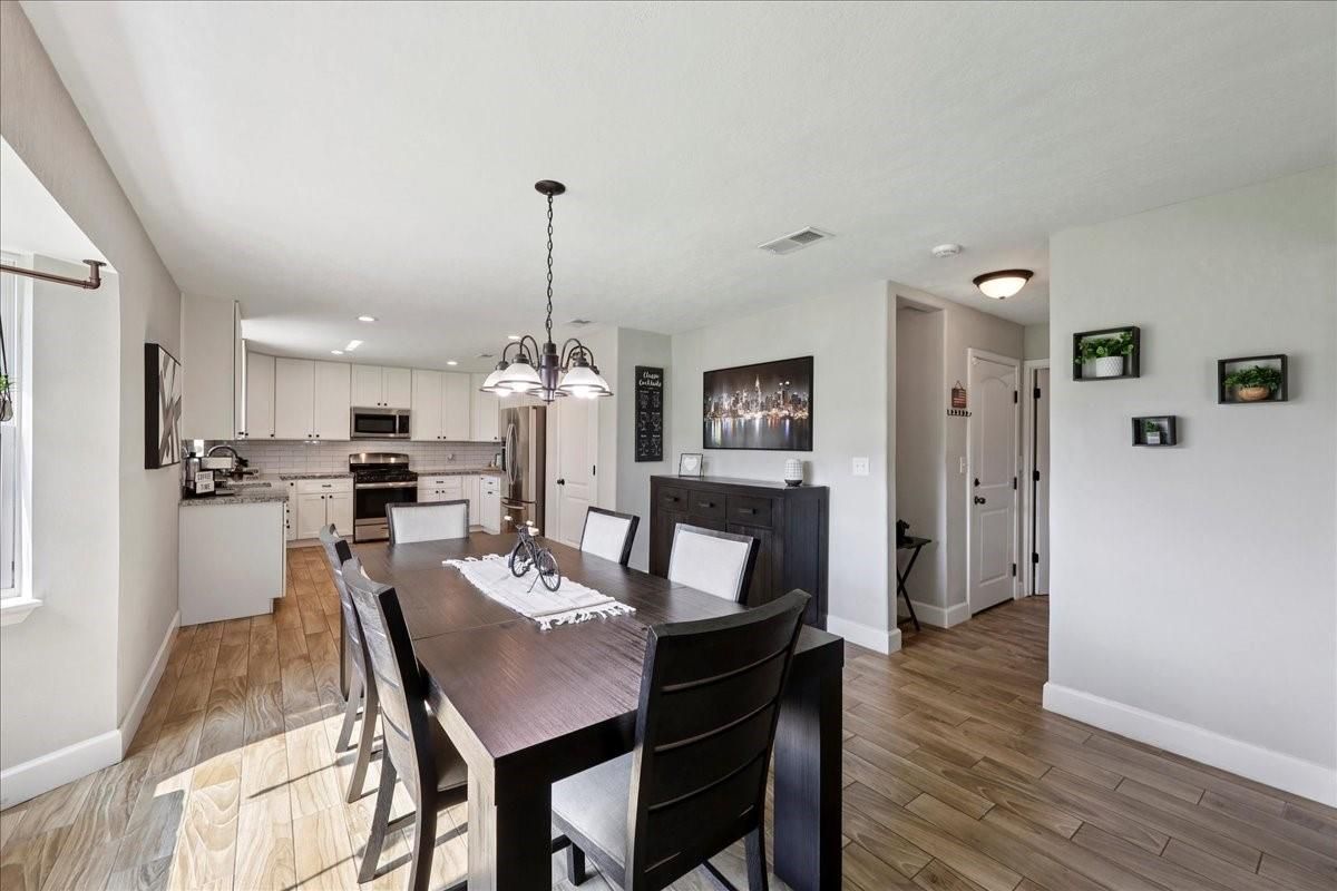 Dining room, Interior, Kitchen, Pendant Lights, Recessed Lighting, Stainless Steel Appliances, Wood Texture Flooring