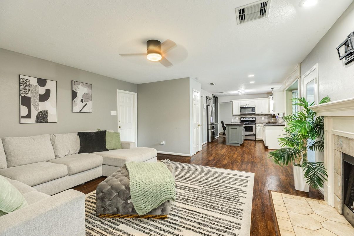 Fireplace, Interior, Kitchen, Living room, Recessed Lighting, Stainless Steel Appliances, Wood Texture Flooring