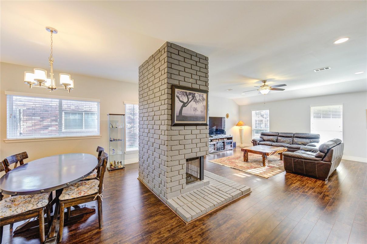 Dining room, Fireplace, Interior, Living room, Recessed Lighting, Stone Walls, Wood Texture Flooring