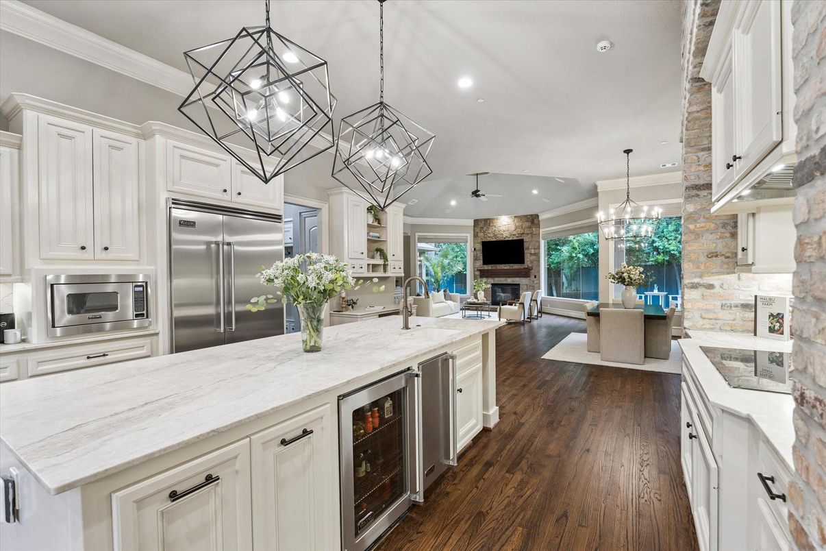 Dining room, Fireplace, Interior, Kitchen, Living room, Pendant Lights, Recessed Lighting, Stainless Steel Appliances, Wood Texture Flooring
