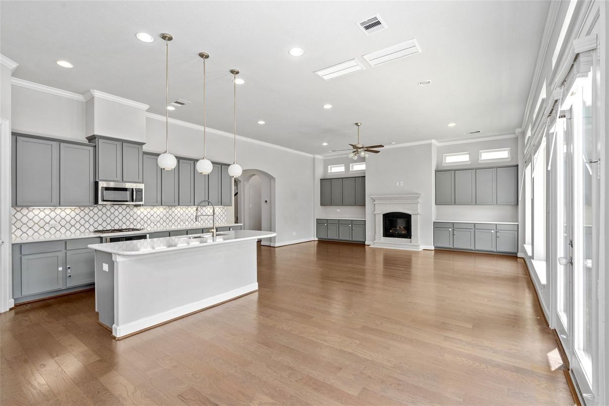 Empty room, Fireplace, Interior, Kitchen, Pendant Lights, Recessed Lighting, Wood Texture Flooring