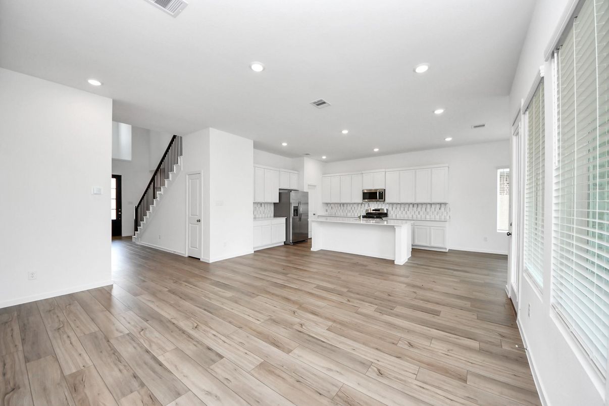 Empty room, Interior, Kitchen, Recessed Lighting, Stainless Steel Appliances, Wood Texture Flooring
