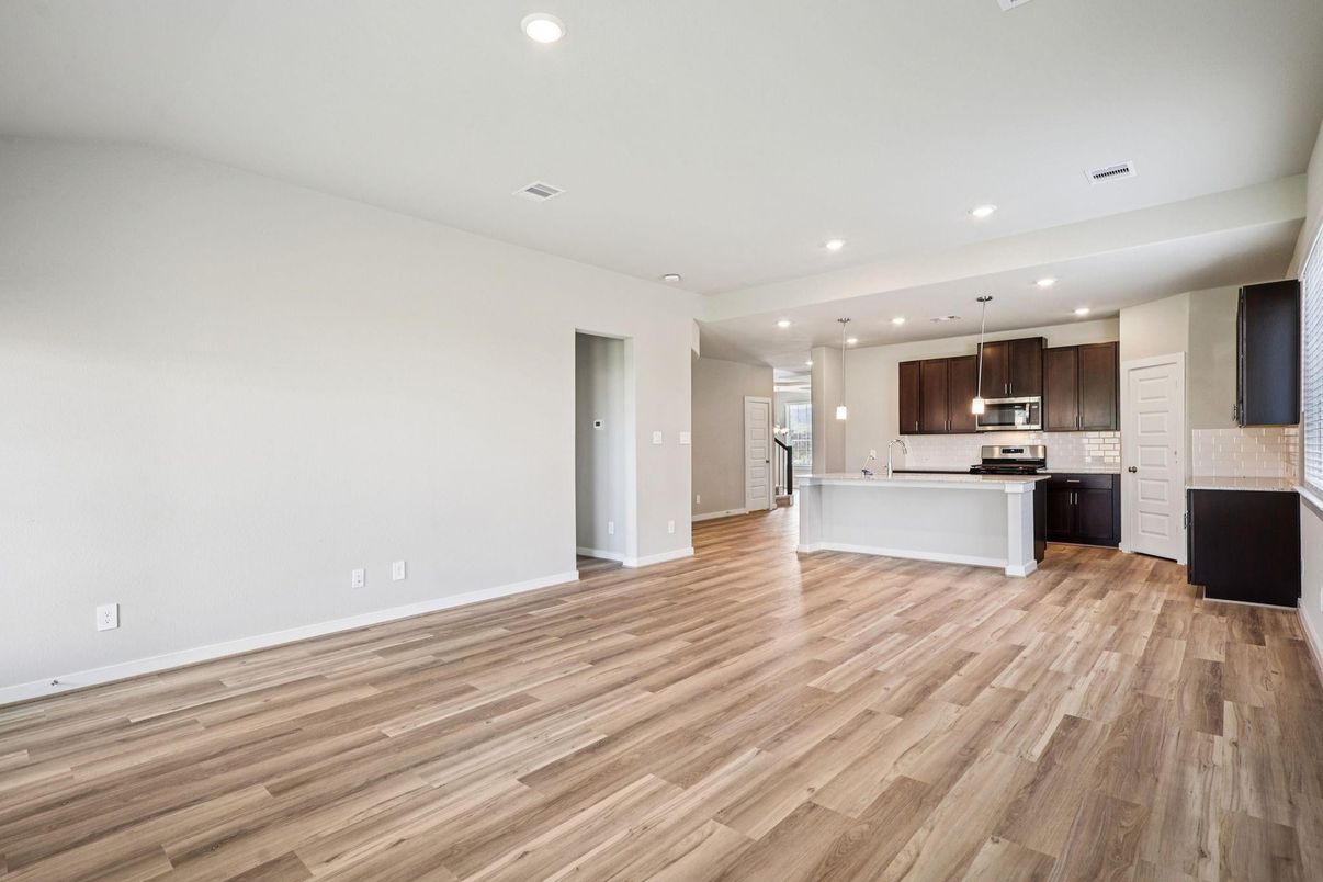 Empty room, Interior, Kitchen, Pendant Lights, Recessed Lighting, Stainless Steel Appliances, Wood Texture Flooring