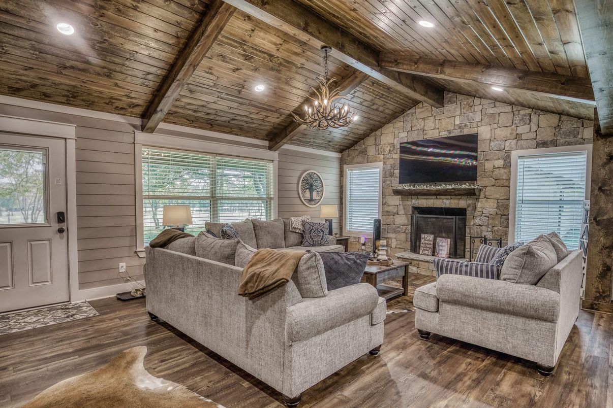 Chandelier, Fireplace, Interior, Living room, Recessed Lighting, Stone Walls, Wooden Beams, Wooden Ceilings, Wood Texture Flooring