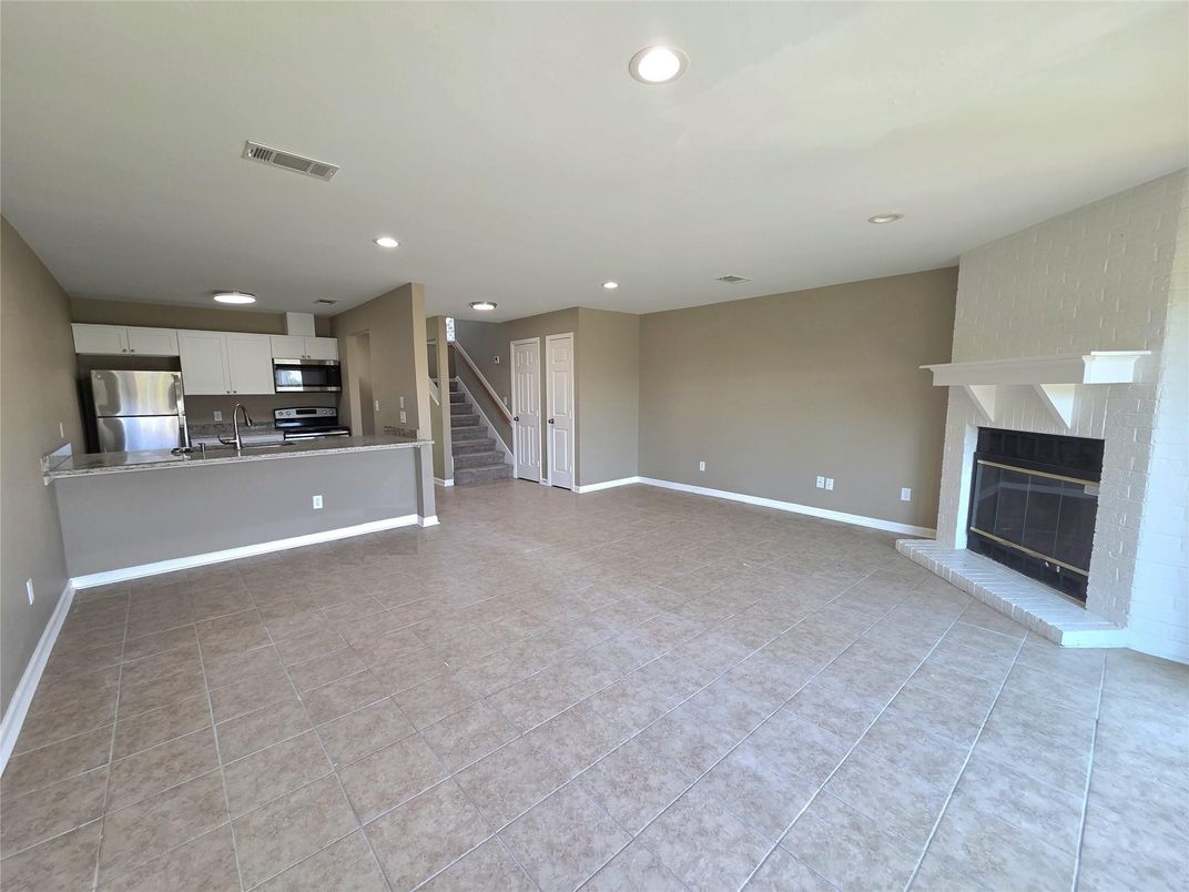 Empty room, Fireplace, Interior, Kitchen, Recessed Lighting, Stainless Steel Appliances
