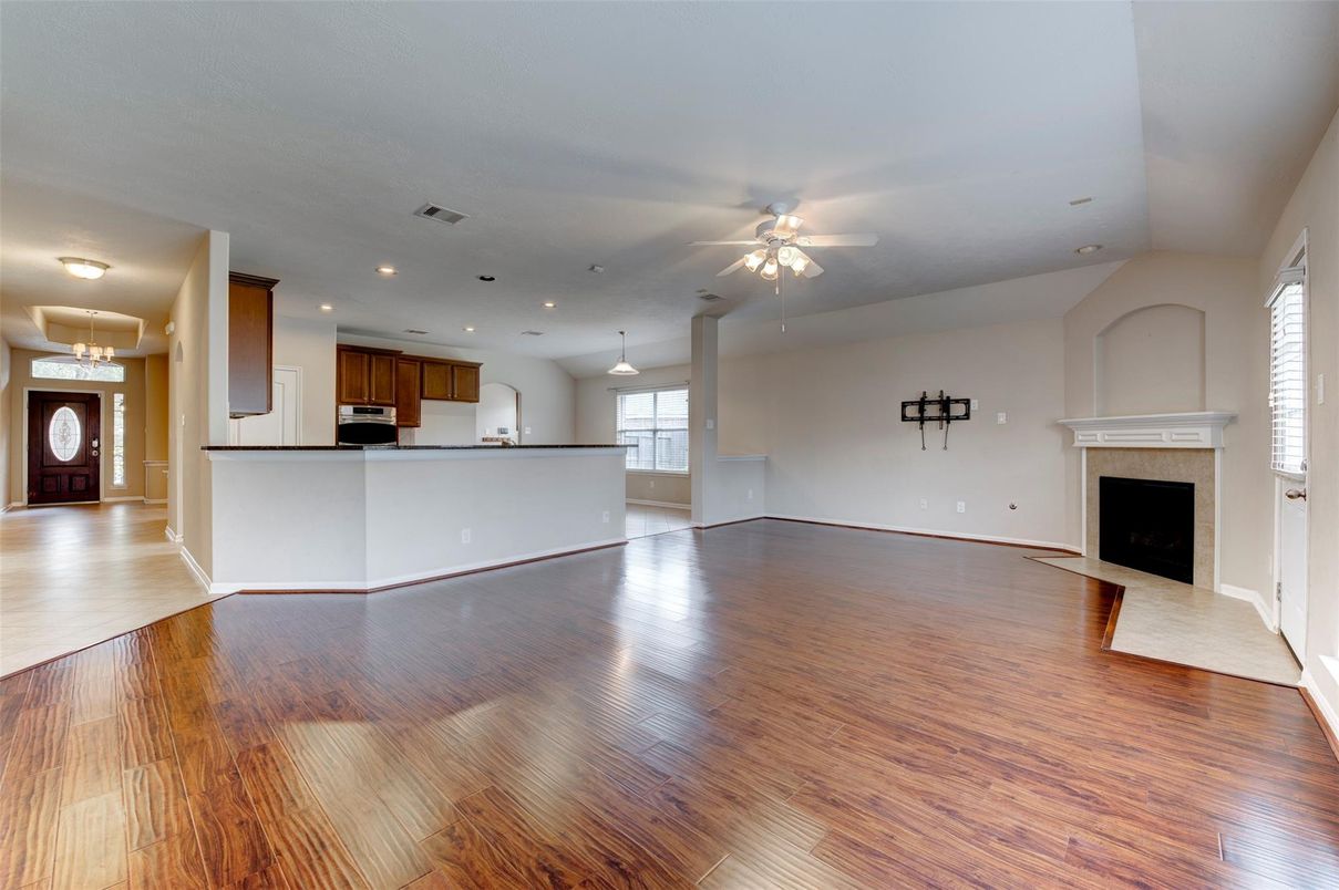 Empty room, Fireplace, Interior, Kitchen, Pendant Lights, Recessed Lighting, Wood Texture Flooring
