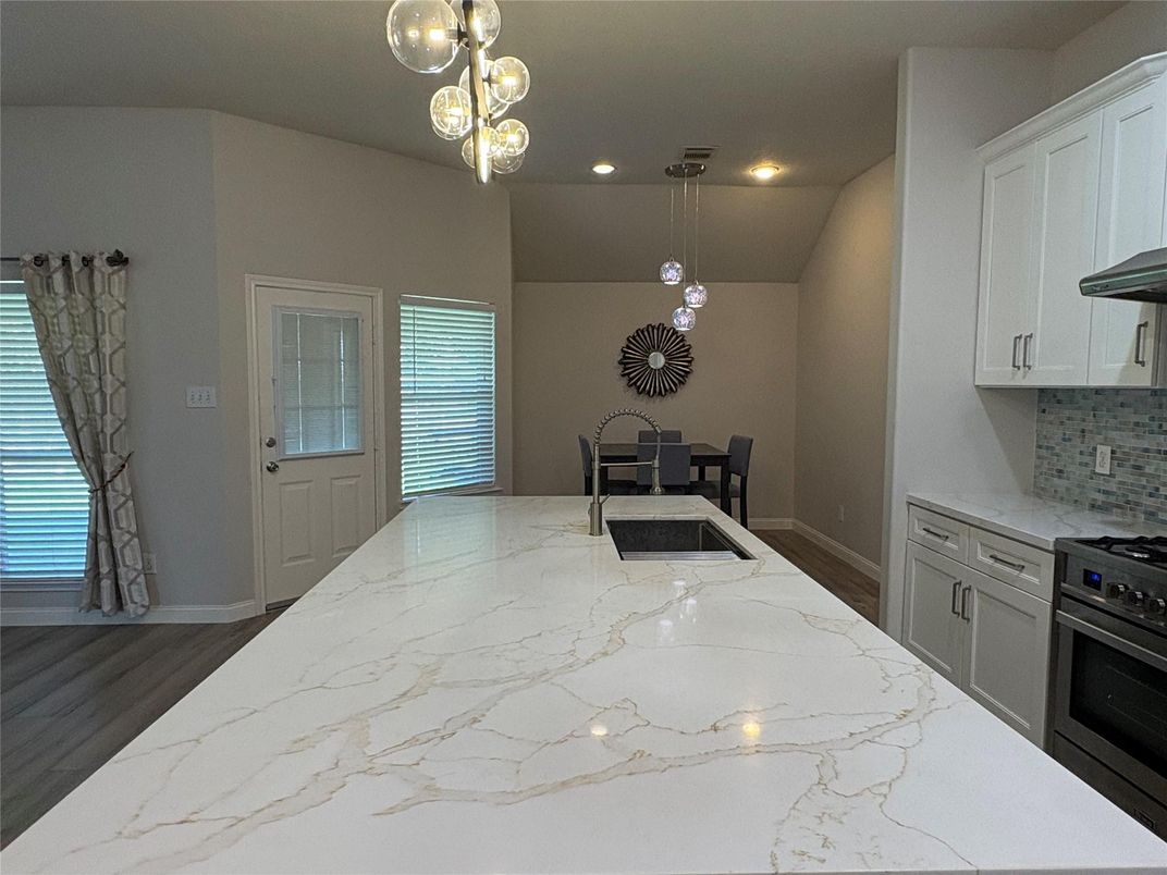 Dining room, Interior, Kitchen, Pendant Lights, Recessed Lighting, Stainless Steel Appliances, Wood Texture Flooring