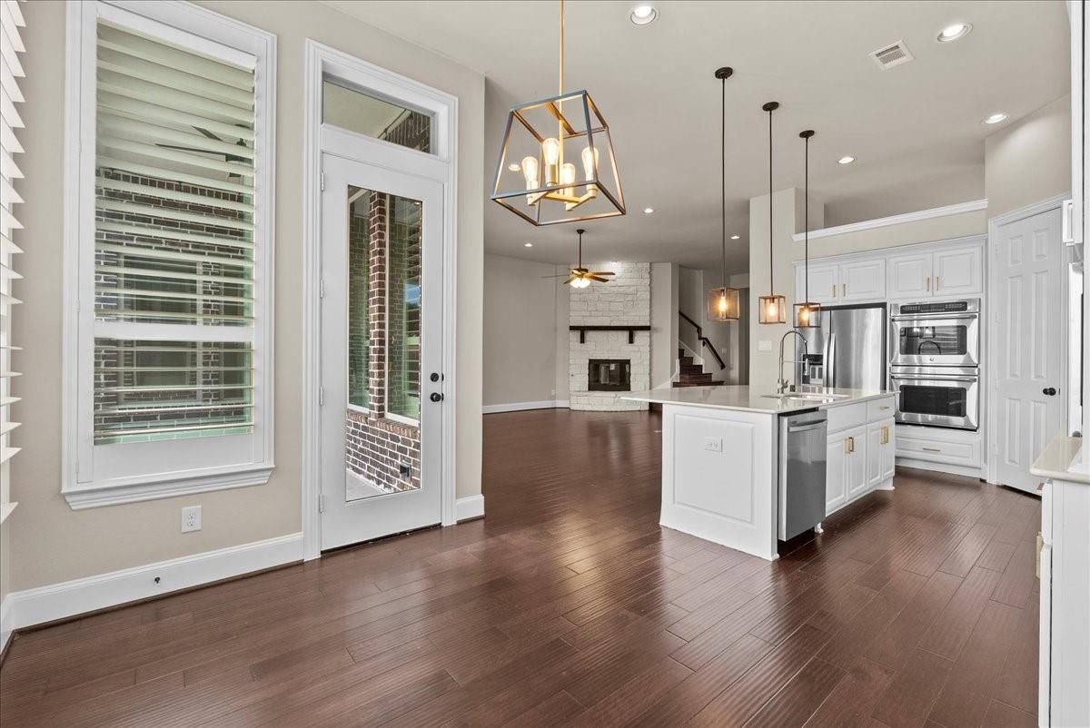 Fireplace, Interior, Kitchen, Pendant Lights, Recessed Lighting, Stainless Steel Appliances, Wood Texture Flooring