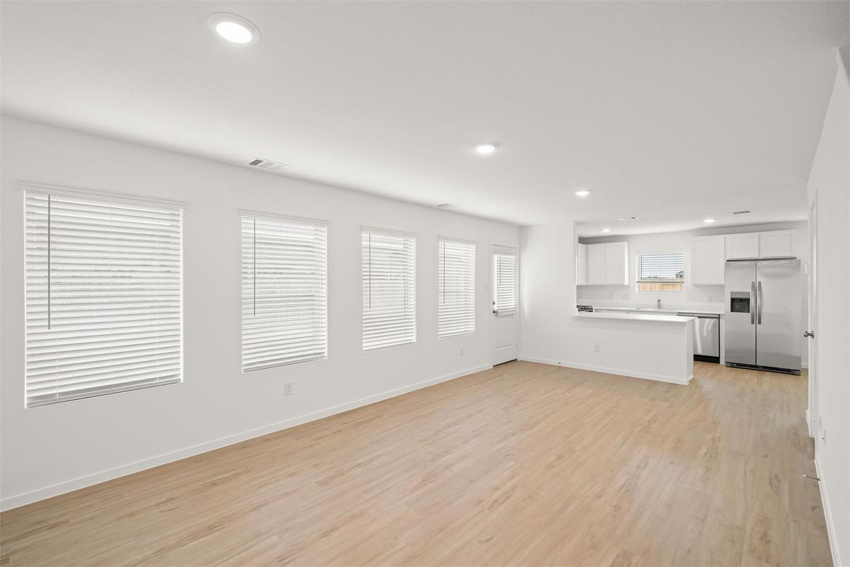 Empty room, Interior, Kitchen, Recessed Lighting, Stainless Steel Appliances, Wood Texture Flooring