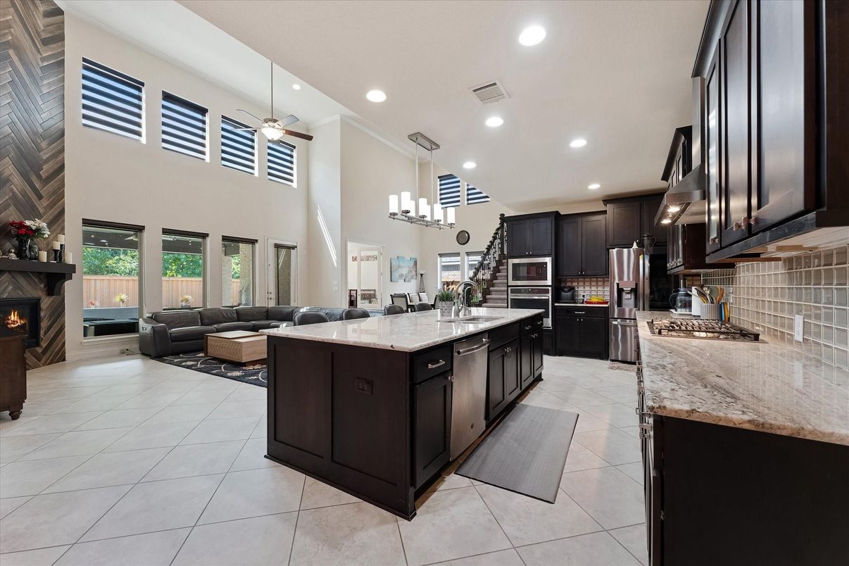 Chandelier, Dining room, Fireplace, Interior, Kitchen, Living room, Recessed Lighting, Stainless Steel Appliances