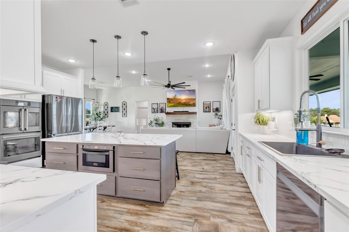 Fireplace, Interior, Kitchen, Pendant Lights, Recessed Lighting, Stainless Steel Appliances, Wood Texture Flooring