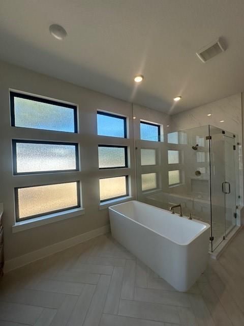 Bathroom, Free Standing Baths, Glass Shower, Interior, Marble Walls, Recessed Lighting, Wood Texture Flooring
