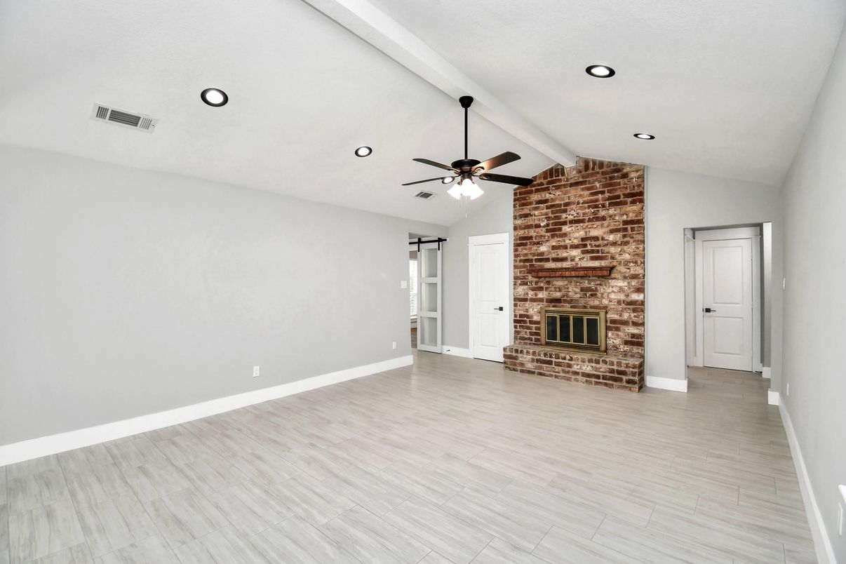 Empty room, Fireplace, Interior, Recessed Lighting, Stone Walls, Wood Texture Flooring