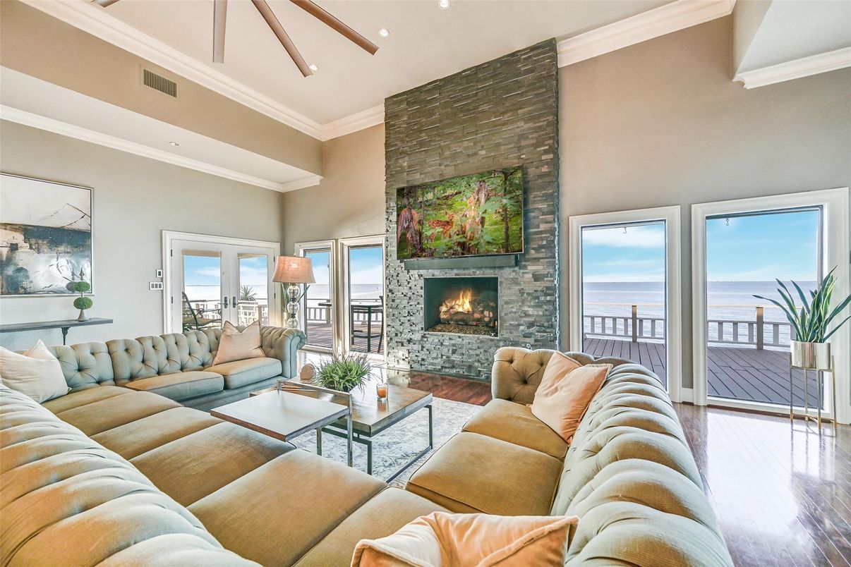 Fireplace, Interior, Living room, Recessed Lighting, Stone Walls, Water, Wood Texture Flooring
