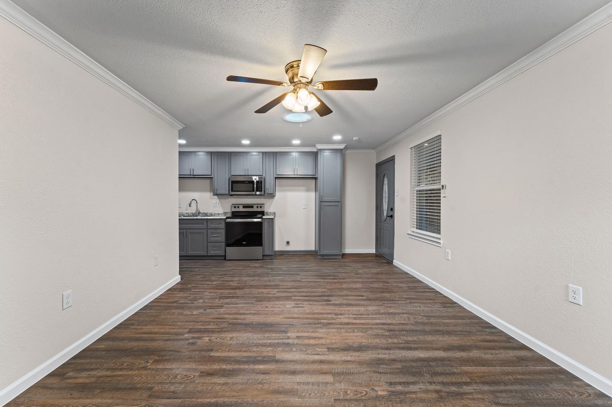 Empty room, Interior, Kitchen, Recessed Lighting, Stainless Steel Appliances, Wood Texture Flooring