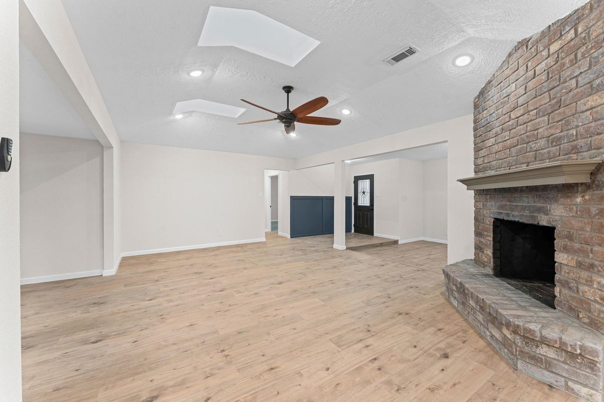 Empty room, Fireplace, Interior, Recessed Lighting, Stone Walls, Wood Texture Flooring