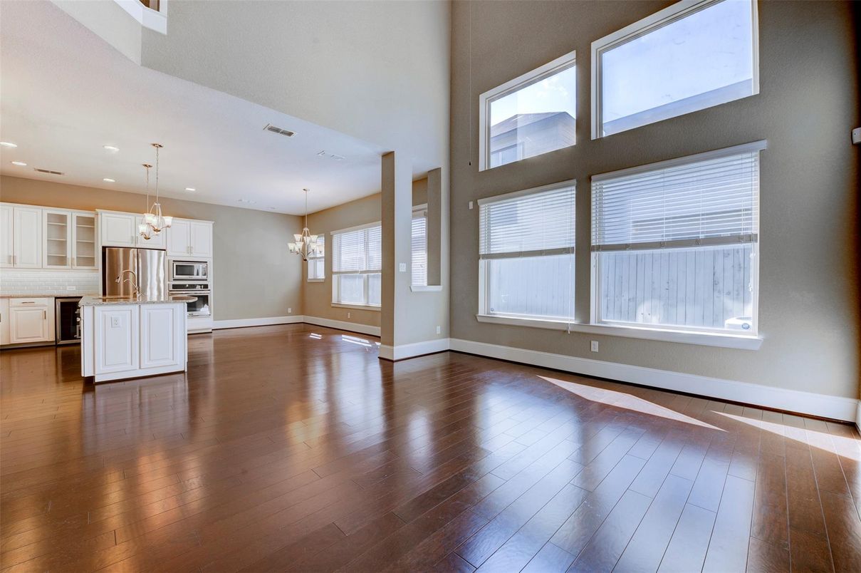Chandelier, Empty room, Interior, Kitchen, Pendant Lights, Recessed Lighting, Stainless Steel Appliances, Wood Texture Flooring