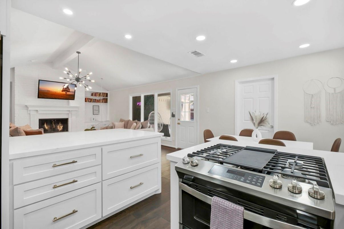 Dining room, Fireplace, Interior, Kitchen, Living room, Pendant Lights, Recessed Lighting, Stainless Steel Appliances, Wood Texture Flooring