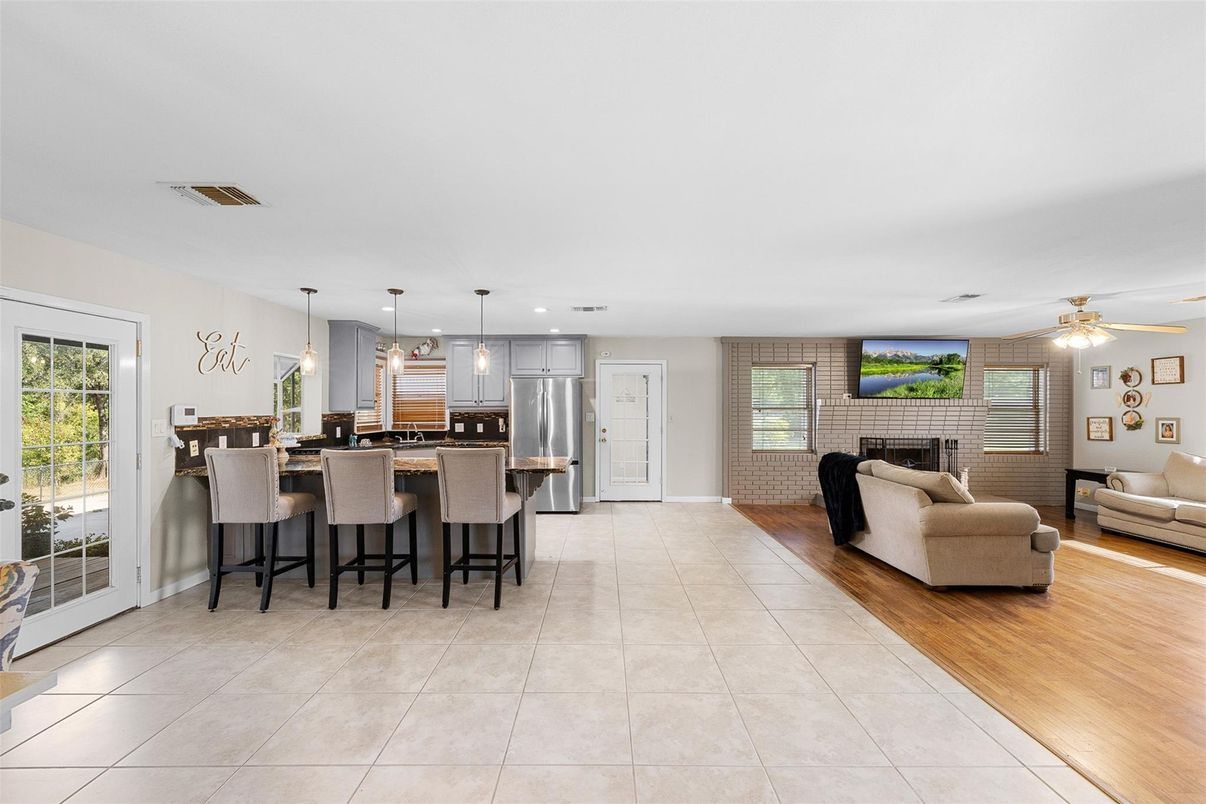 Fireplace, Interior, Kitchen, Living room, Pendant Lights, Stainless Steel Appliances, Stone Walls, Wood Texture Flooring