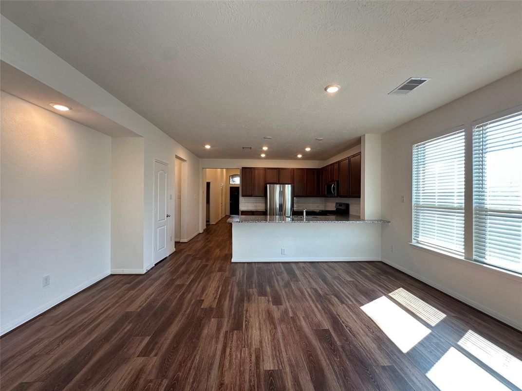Empty room, Interior, Kitchen, Recessed Lighting, Stainless Steel Appliances, Wood Texture Flooring