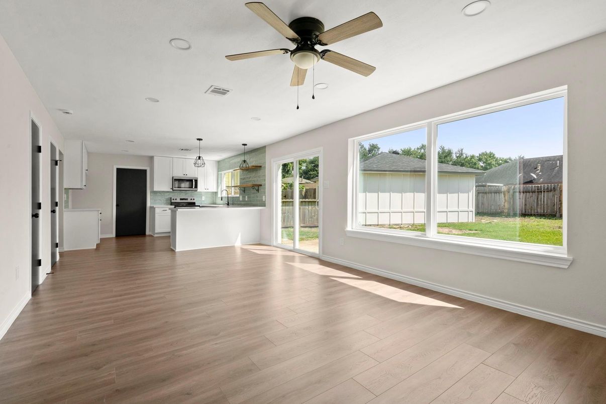 Empty room, Interior, Kitchen, Pendant Lights, Recessed Lighting, Stainless Steel Appliances, Wood Texture Flooring