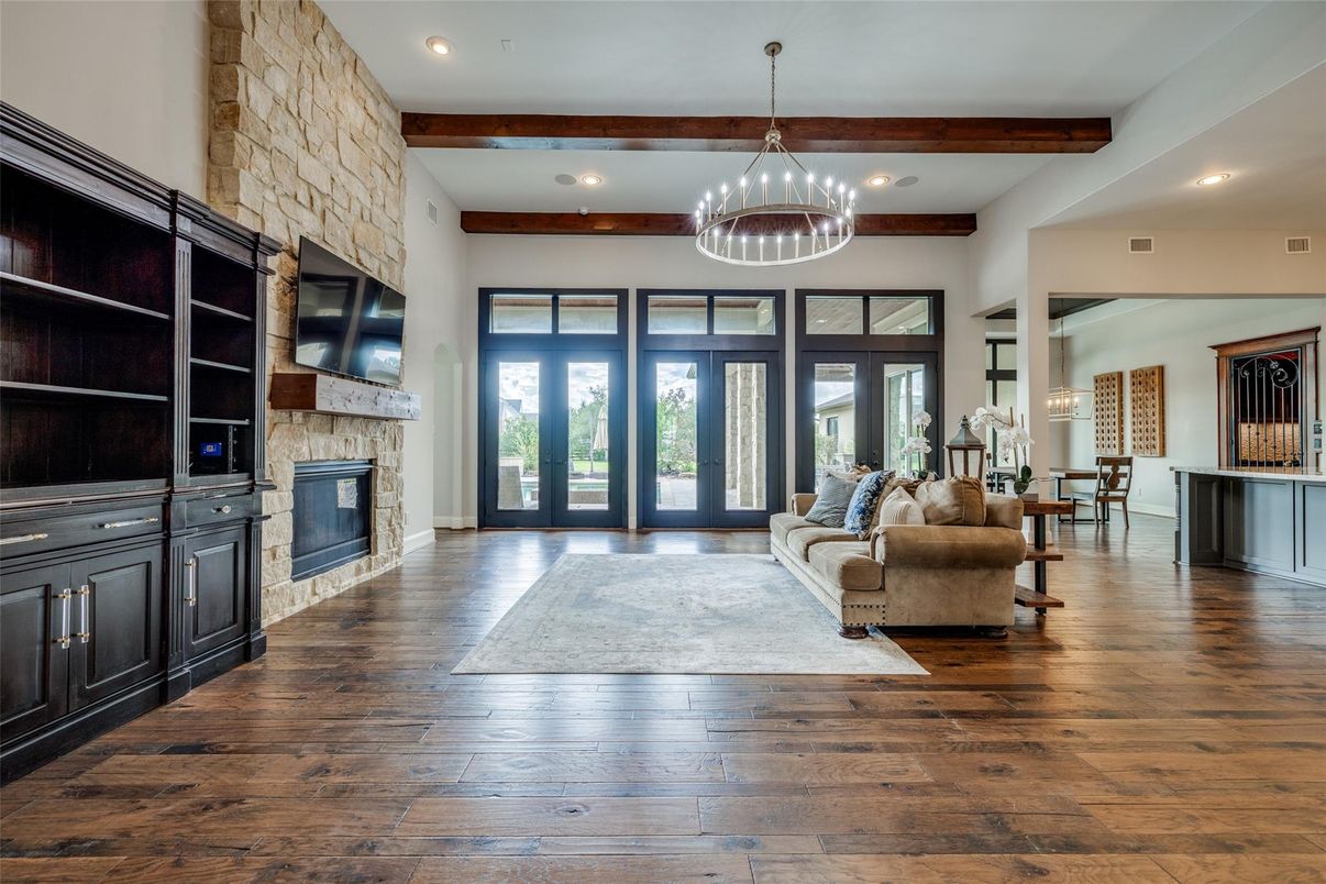 Chandelier, Fireplace, Interior, Living room, Recessed Lighting, Stone Walls, Wooden Beams, Wood Texture Flooring