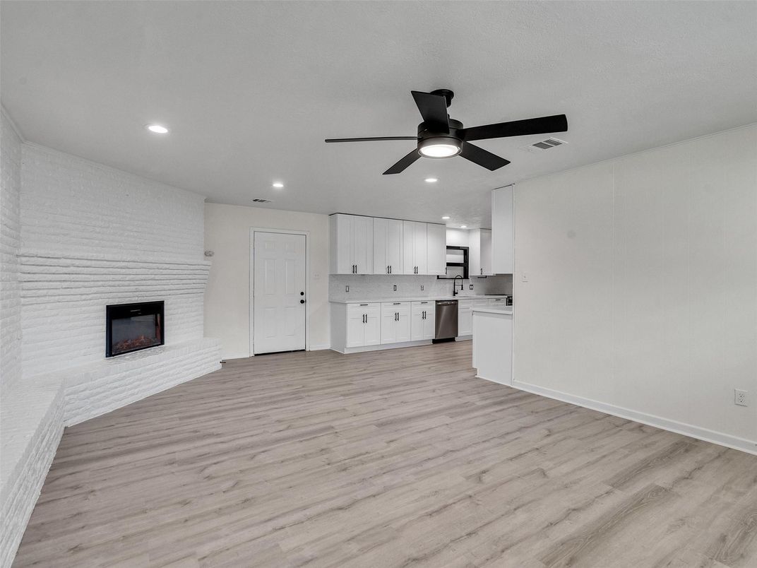 Empty room, Fireplace, Interior, Kitchen, Recessed Lighting, Wood Texture Flooring