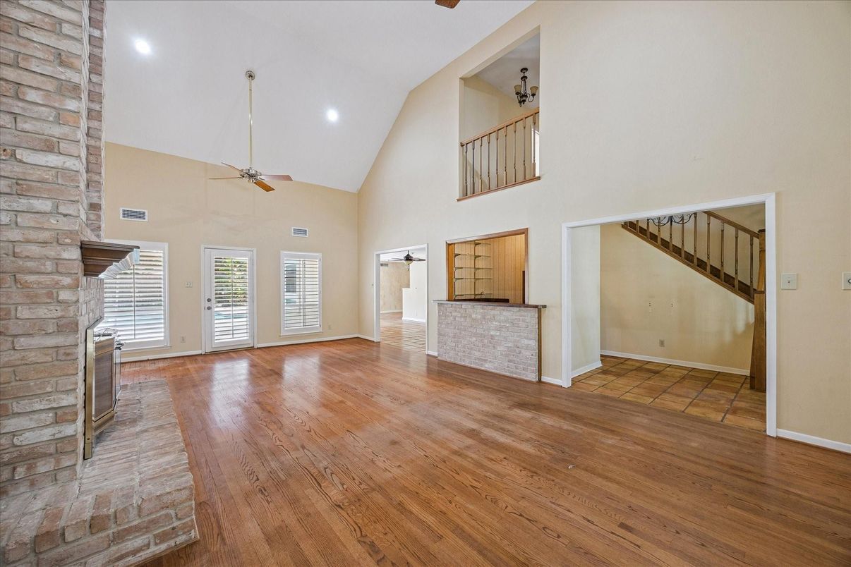 Empty room, Fireplace, Interior, Recessed Lighting, Stone Walls, Wood Texture Flooring