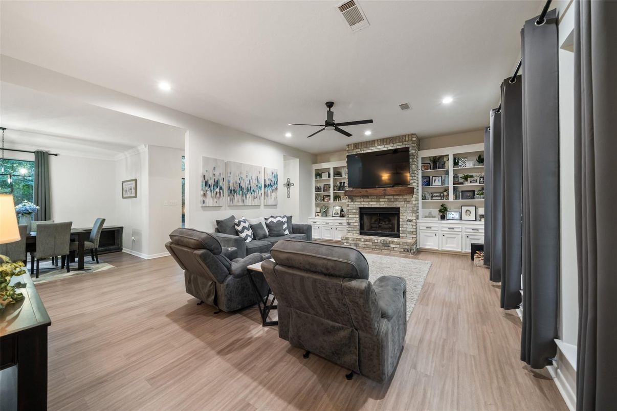 Dining room, Fireplace, Interior, Living room, Recessed Lighting, Stone Walls, Wood Texture Flooring