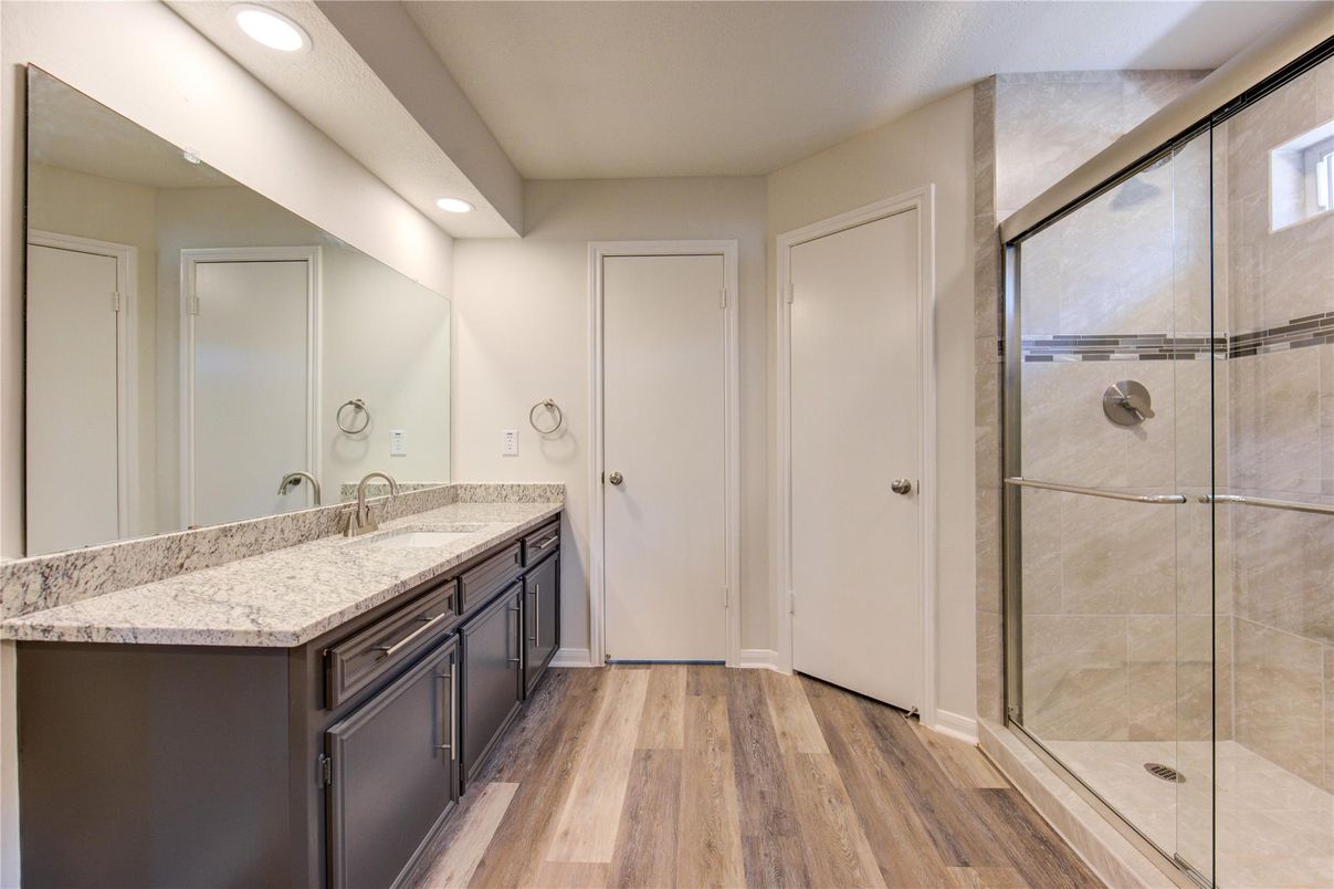 Bathroom, Dual Sink Vanities, Glass Shower, Interior, Recessed Lighting, Wood Texture Flooring