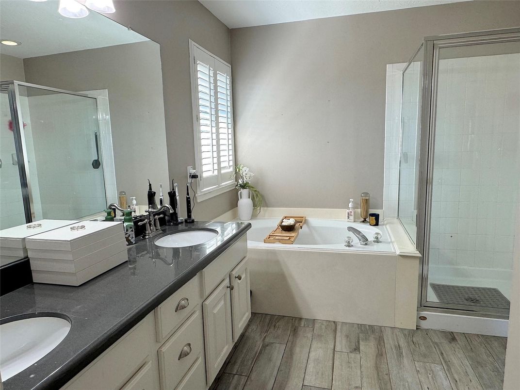Bathroom, Dual Sink Vanities, Glass Shower, Interior, Recessed Lighting, Wood Texture Flooring