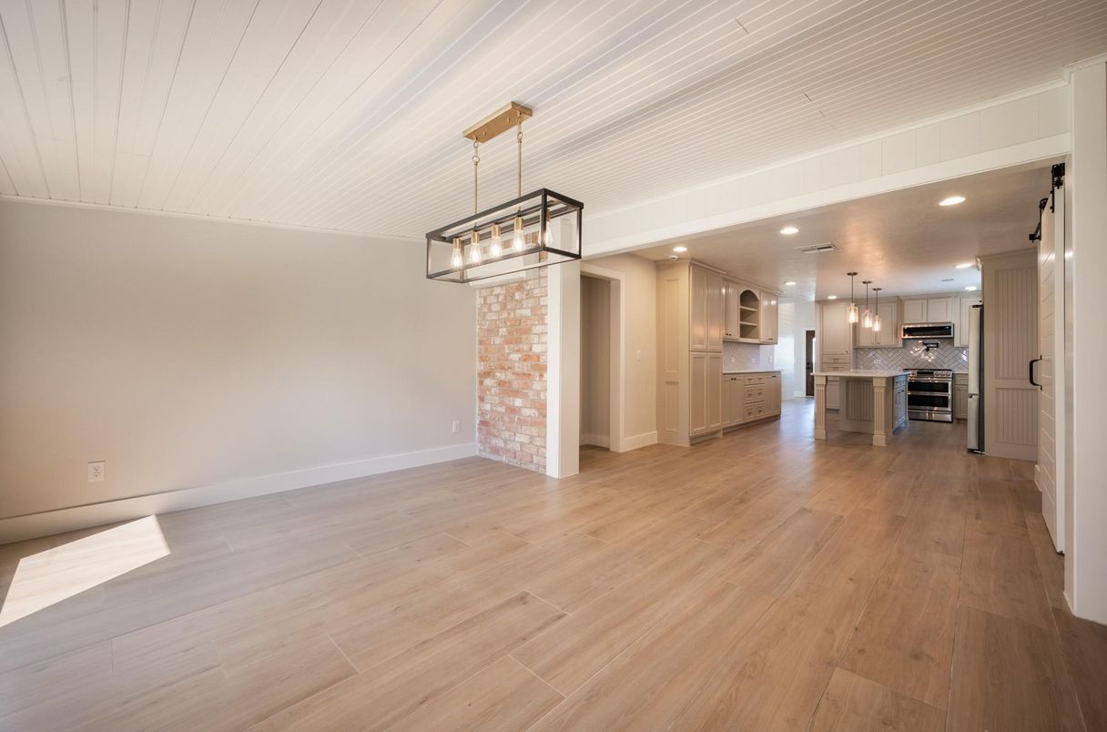 Empty room, Interior, Kitchen, Pendant Lights, Recessed Lighting, Stainless Steel Appliances, Wood Texture Flooring