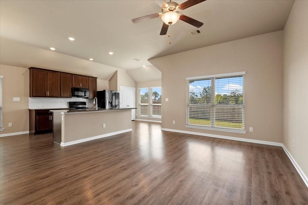 Empty room, Interior, Kitchen, Recessed Lighting, Stainless Steel Appliances, Wood Texture Flooring