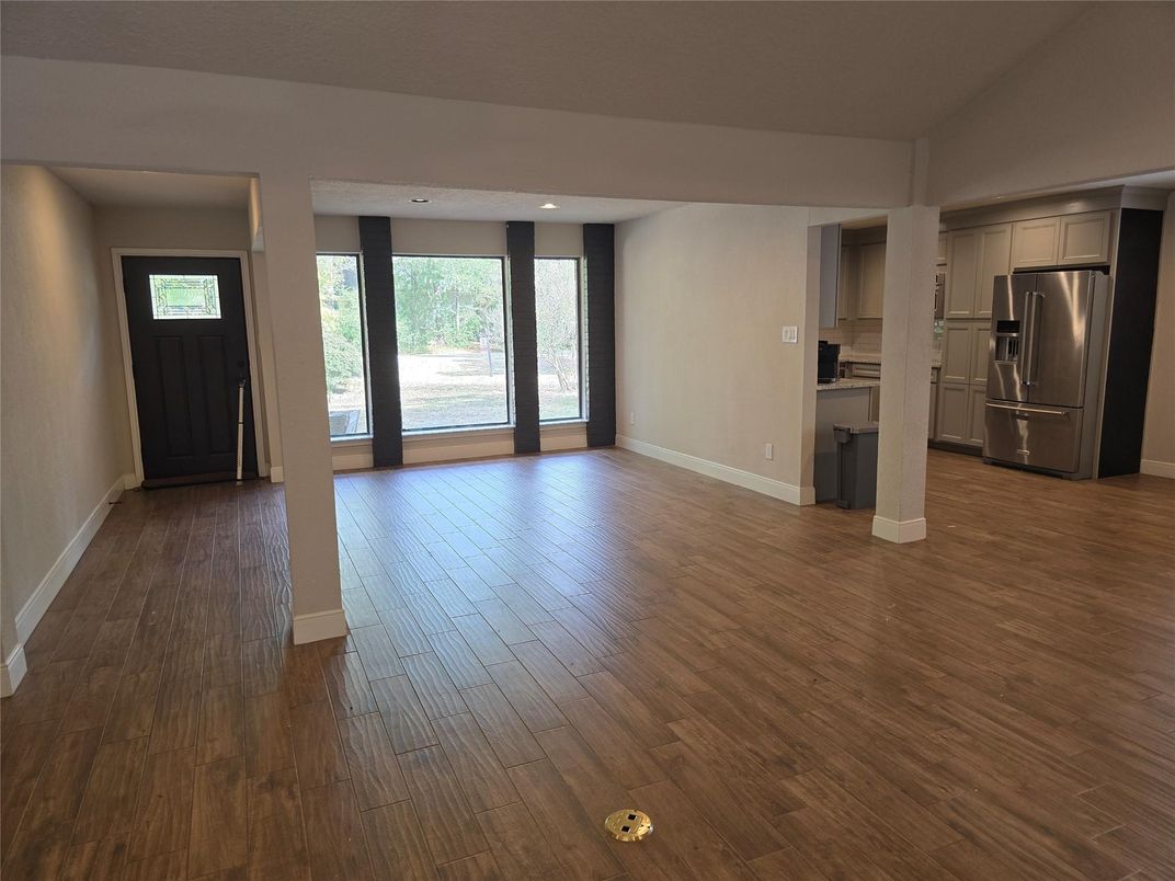 Empty room, Interior, Kitchen, Recessed Lighting, Stainless Steel Appliances, Wood Texture Flooring