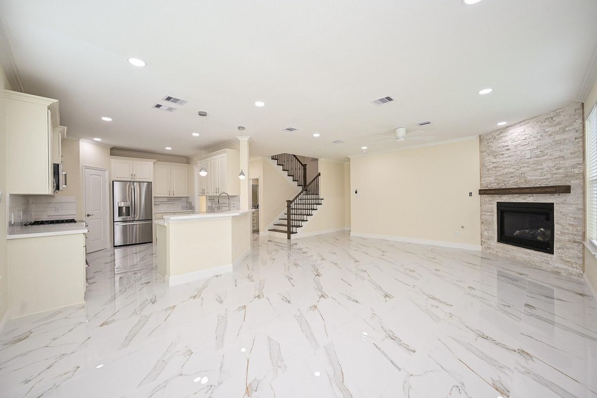Empty room, Fireplace, Interior, Kitchen, Marble, Recessed Lighting, Stainless Steel Appliances, Stone Walls