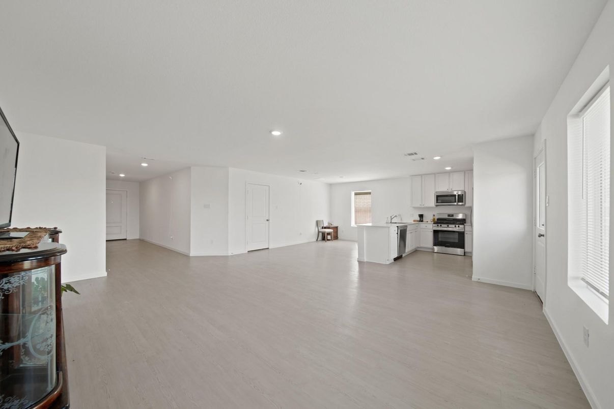 Empty room, Interior, Kitchen, Recessed Lighting, Stainless Steel Appliances, Wood Texture Flooring