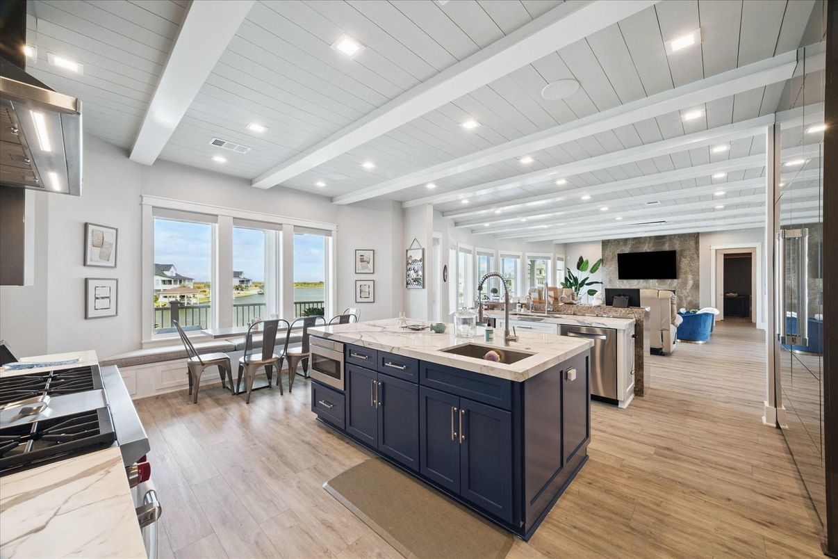 Dining room, Fireplace, Interior, Kitchen, Recessed Lighting, Stainless Steel Appliances, Wood Texture Flooring