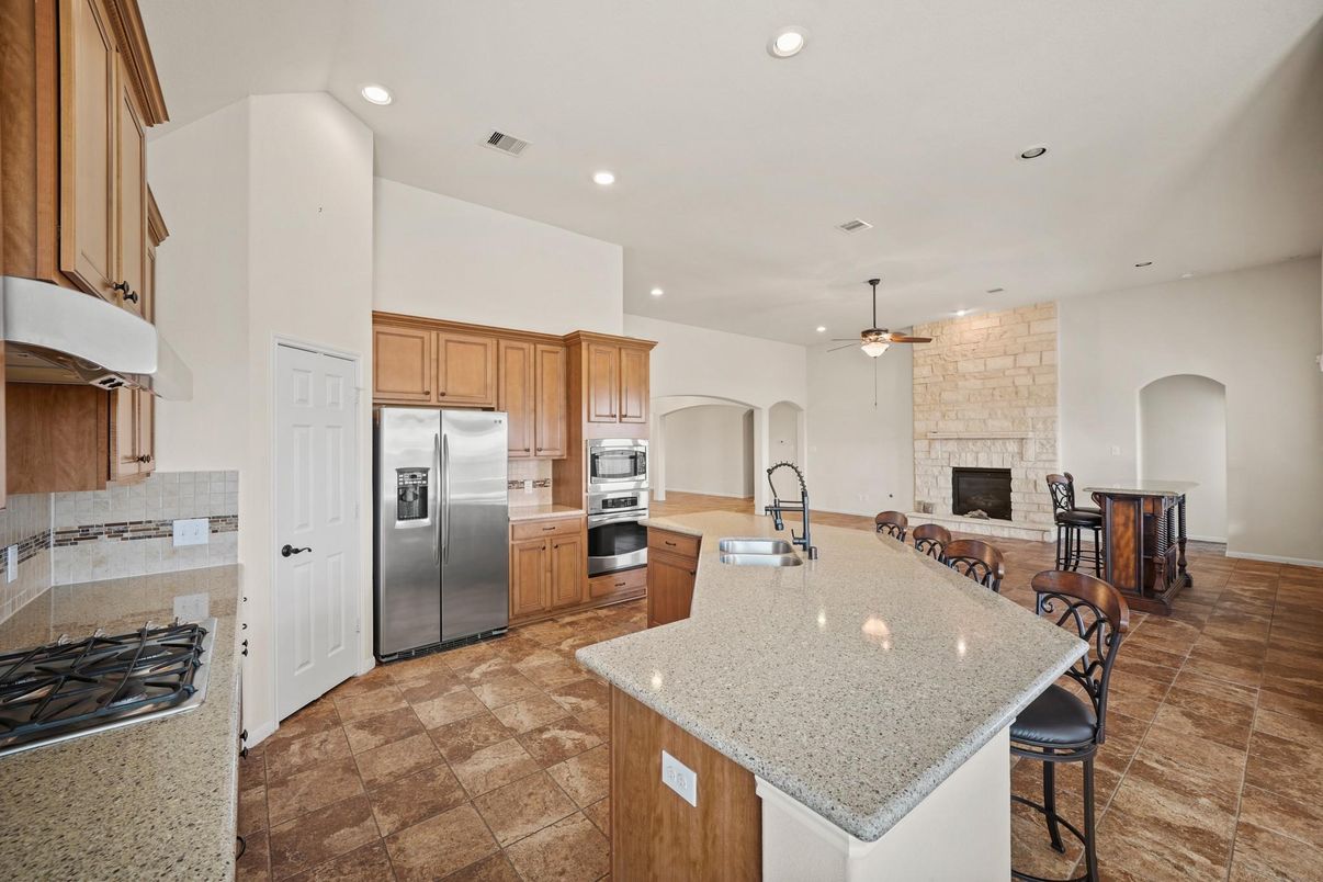 Fireplace, Interior, Kitchen, Recessed Lighting, Stainless Steel Appliances, Stone Walls