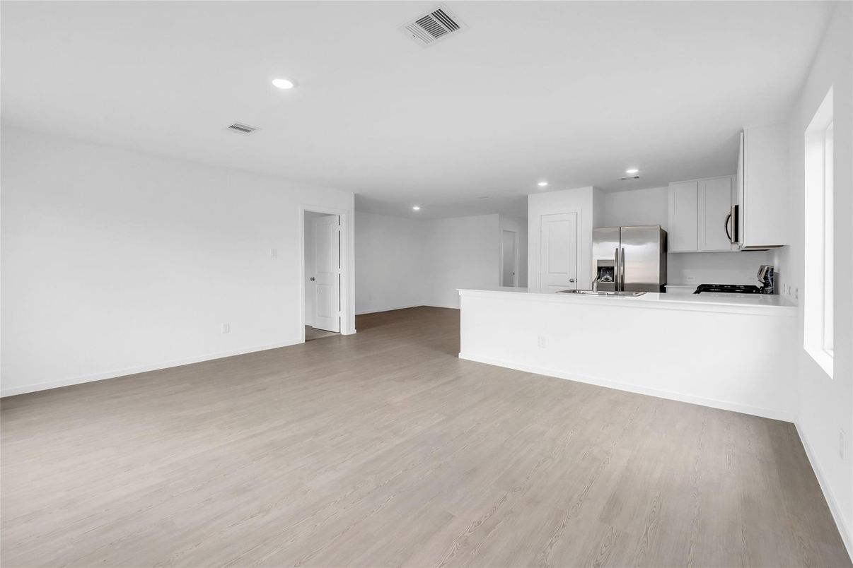 Empty room, Interior, Kitchen, Recessed Lighting, Stainless Steel Appliances, Wood Texture Flooring