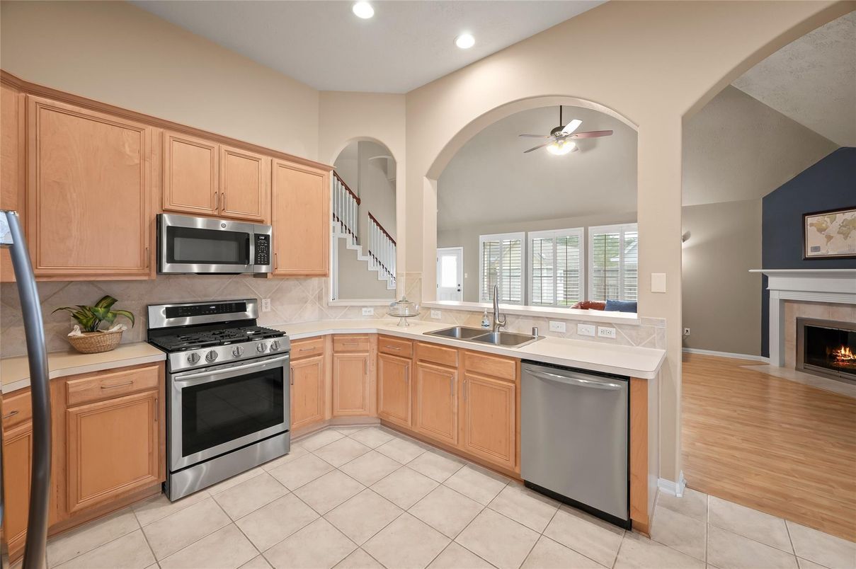 Fireplace, Interior, Kitchen, Recessed Lighting, Stainless Steel Appliances, Wood Texture Flooring